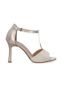 Witte en metallic gouden hoge hak sandaal met een enkelbandje, T-bar ontwerp, open teen en gladde afwerking. Beschikt over een slanke stiletto hak.