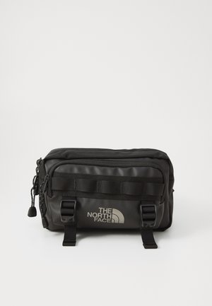 Sac banane noir compact The North Face avec plusieurs compartiments zippés et sangles réglables avec boucle à l'avant.