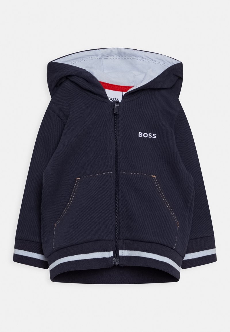 Navy zip-up hoodie i strukturerad tyg, med dragsko i huvan, framfickor och randiga ärmslut med kontrasterande sömmar.
