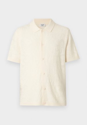 Korte mouwen crème poloshirt met een gestructureerd bloemmotief, een knoopsluiting en een geribbelde kraag, gemaakt van zacht stof.