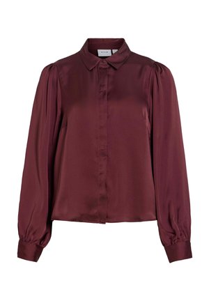 Blusa bordeaux in satin a maniche lunghe con colletto a punta, polsini con bottoni e patta frontale con bottoni nascosti.