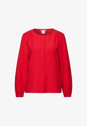 Punainen pitkähihainen paita, jossa on tekstuuripinta, pyöreä pääntie ja nappisulku. Sisältää hillittyä laskostusta olkapäiden lähellä.