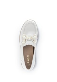White leather slip-on shoe with a rounded toe, featuring a decorative cream chain accent across the front and a textured insole.
