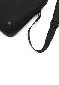 Black messenger bag with a smooth texture, featuring a zipper closure, adjustable strap, and a round logo detail.