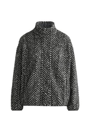 Svart och vit herringbone-mönstrad fleecejacka med hög krage och långa ärmar. Mjuk textur, löss passform och inga synliga knäppningar.