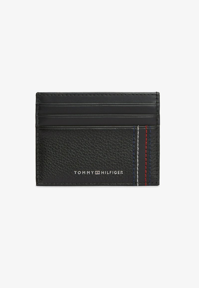 Black leather Tommy Hilfiger cardholder with four card slots and red, white, and blue stitching detail on the right side.