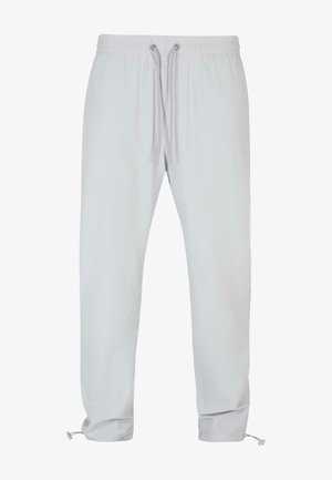 Světle šedé kalhoty s elastickým pasem a stahovací šňůrkou, zúžené nohavice a nastavitelné manžety. Hladká textura, jednoduchý design, bez vzorů.