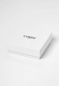 Weißer rechteckiger Geschenkkarton mit glänzender Oberfläche. Mit zentriertem, fettem schwarzen Text "CHRIST seit 1863." Sauberes und minimales Design.