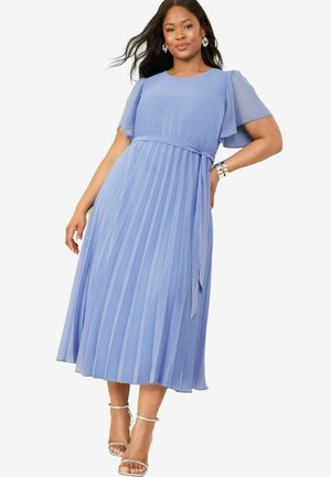 Pleated blue dress with short puff sleeves, a waist tie, and a flowing A-line silhouette. Worn with silver strappy sandals.