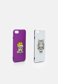 Two phone cases: one purple with a king's face and a yellow crown; the other white featuring a detailed tiger illustration. Both have a matte finish.