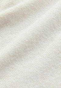 Light beige fabric with a subtle texture, featuring a soft, slightly fuzzy appearance; smooth surface and even weave pattern.