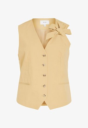 Gilet sans manches beige pour femmes avec col en V, boutons sur le devant, deux petites poches avant et un grand nœud en tissu sur l'épaule gauche.