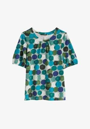 Krótki top z krótkim rękawem i okrągłym dekoltem, z wielokolorowym wzorem niebieskich, zielonych i czarnych okręgów na białym tle.