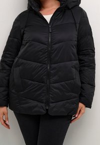 Black puffer jacket with a zip front, hood, and side pockets. Features quilted texture and smooth fabric, suitable for cold weather.