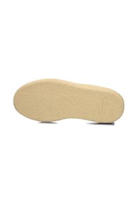 Sole di scarpa in gomma, colore beige, superficie testurizzata con una leggera curvatura, con un logo impresso nella zona del tallone.