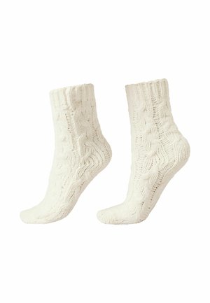 Chaussettes blanches en tricot avec un motif de câble, présentant des bords côtelés, une surface texturée et un design mi-mollet.