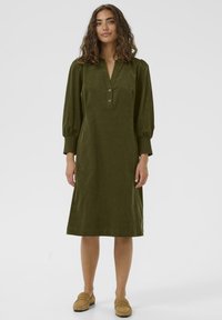 Olive green dress with a V-neck and three buttons, featuring puffed sleeves, a relaxed fit, and knee-length design. Soft, textured fabric.