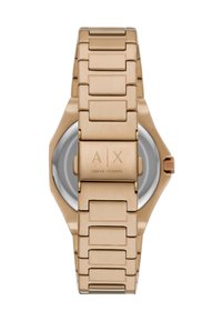 Roze gouden metalen horloge met een hexagonale kast en geïntegreerde schakelarmband. Beschikt over een reliëflogo op de sluiting en een minimalistische wijzerplaat.