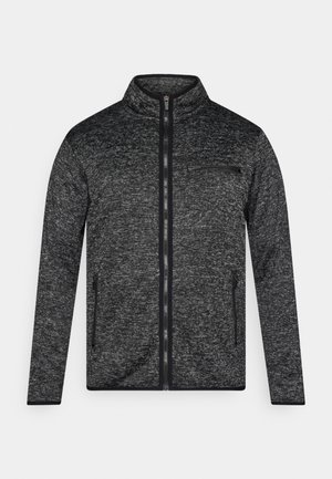 Sivý pletený sveter s vysokým golierom, celopredným zipsom, vreckom na zips na hrudi a dvoma bočnými vreckami. Dizajn dopĺňajú čierne akcenty.