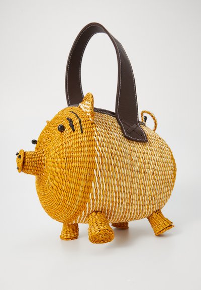 Woven straw handbag in yellow and white, shaped like a pig with a brown handle, round body, small ears, and detailed facial features.