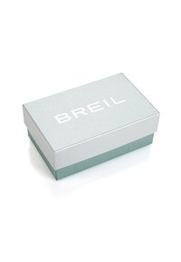 Caja rectangular de color azul claro, tapa texturizada de color plata con "BREIL" impreso en blanco. La base es de un azul claro mate, con bordes limpios y superficie suave.