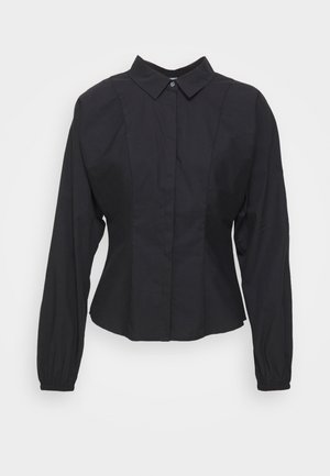 Chemise noire à boutons avec un col, des manches longues, des poignets froncés et des coutures structurées pour un ajustement sur mesure. Tissu en coton.