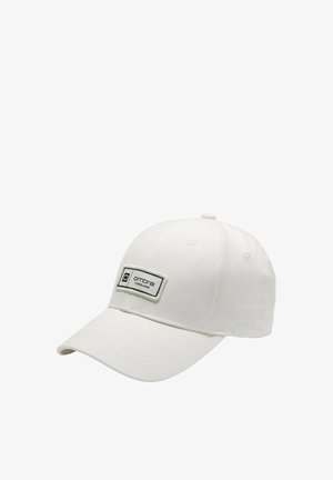 Valkoinen baseball-lippu, joka on valmistettu puuvillakankaasta ja jossa on teksturoidun pinnan, kaareva lippa ja suorakulmainen logopaketti edessä.