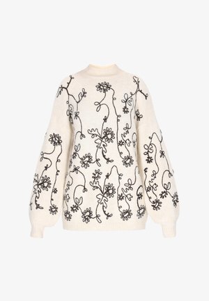 Strikpullover i creme med mørk blomsterbroderi, der har en høj halsudskæring og oversized ballonærmer. Blød tekstur, afslappet pasform.