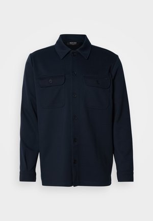 Dark navy long-sleeve button-up shirt with collar and two buttoned chest pockets, displayed against a plain light background.