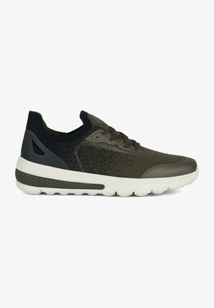 Olive green athletic shoe with a textured knit upper, rubber sole, and contrasting dark accents. Features a sock-like collar and lightweight design.