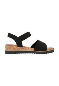 Sandali in suede nero con tacco a zeppa in sughero, ampia fascia anteriore, cinturini alla caviglia regolabili e suola in gomma testurizzata per una migliore aderenza.