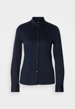 Navy long-sleeve shirt with a pointed collar, front button closure, and structured cuffs. Made from a smooth, soft fabric.