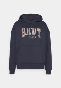 Sweat à capuche bleu marine avec poche kangourou sur le devant, capuche à cordon de serrage et "GANT 1949" brodé en grandes lettres majuscules sur la poitrine.