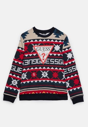 Sweatshirt multicolore arborant des motifs géométriques en rouge, bleu et beige, avec un triangle logo blanc central et des poignets et un ourlet côtelés.