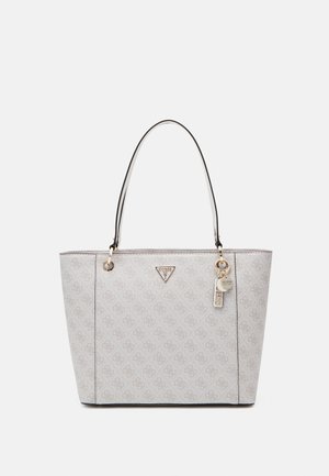Light gray Guess tote bag with all-over logo pattern, dual handles, and metal logo charm on front.