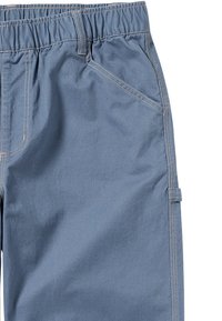 Blauwe katoenen broek van een katoenmengsel met een elastische tailleband, voorzien van zijzakken en contrasterende stikdetails langs de naden.