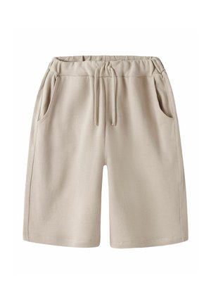 Beżowe bawełniane szorty z elastyczną talią, sznurkiem ściągającym i bocznymi kieszeniami, przedstawione na białym tle.