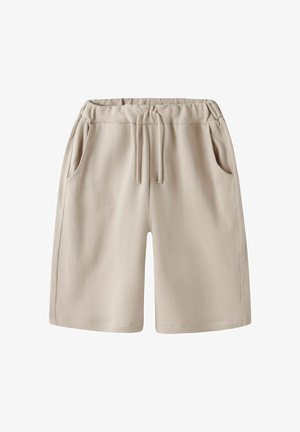 Beige bomuldershorts med elastisk talje, snøre og sidelommer, vist mod en hvid baggrund.
