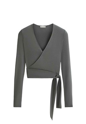 Haut gris à manches longues cache-cœur avec col en V et lien latéral, en tissu côtelé, longueur courte.