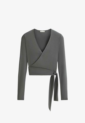Haut gris à manches longues cache-cœur avec col en V et lien latéral, en tissu côtelé, longueur courte.