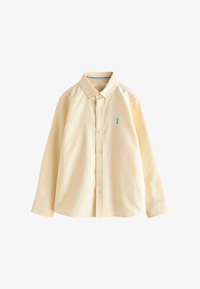 Chemise beige à manches longues, boutonnée, avec un col boutonné et un petit logo homard bleu sur la poitrine gauche.