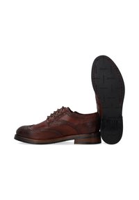 Braunes Leder-Schnürschuh mit Broguemuster, runder Spitze und Schnürdesign. Verfügt über einen gestapelten Absatz und eine strukturierte schwarze Gummisohle.