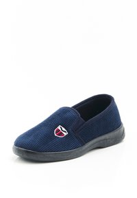 Scarpa slip-on in corduroy blu navy con pannelli laterali in elastico, suola in gomma e un piccolo emblema ricamato con accenti rossi e bianchi.