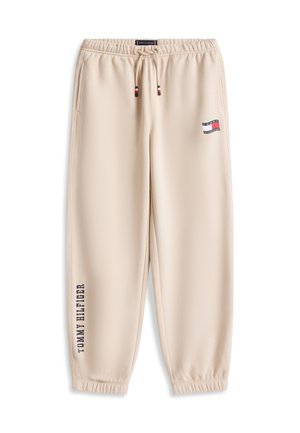 Pantaloni de jogging bej Tommy Hilfiger cu talie elastică, șnur, buzunare laterale, manșete elastice și logo pe coapsă și piciorul inferior.