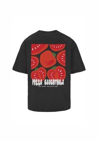 Black cotton t-shirt featuring a graphic design of red tomatoes with green accents and the text "Pizza Essentials" in bold white letters.