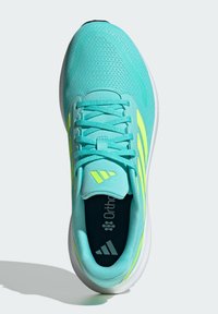 Turquoise athletic shoe with mesh upper, neon yellow accents, flat laces, cushioned collar, and white rubber outsole.