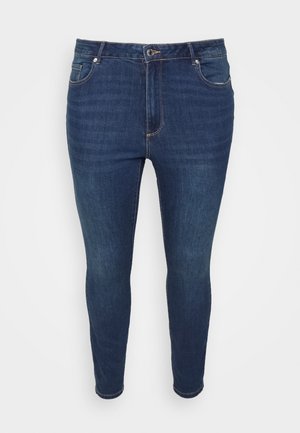 Tmavomodré denimové skinny jeans s priliehavým strihom, dizajnom s piatimi vreckami, kovovým zapínaním a jemným prešívaním pozdĺž švov.