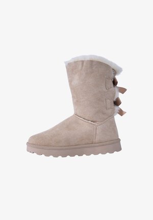 Bota de ante beige con un suave forro de piel y una suela de goma plana. Presenta tres lazos decorativos a lo largo de la parte posterior. Altura hasta la mitad de la pantorrilla.