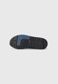 Rubber shoe sole features a textured black surface with blue accents, designed for traction and durability. Specific tread pattern visible.