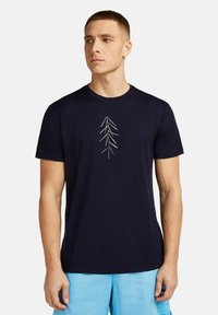 Navy blue cotton t-shirt featuring a white embroidered tree design on the front, short sleeves, and a crew neckline.
